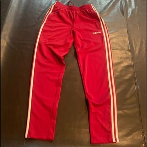 Red and white adidas track pants